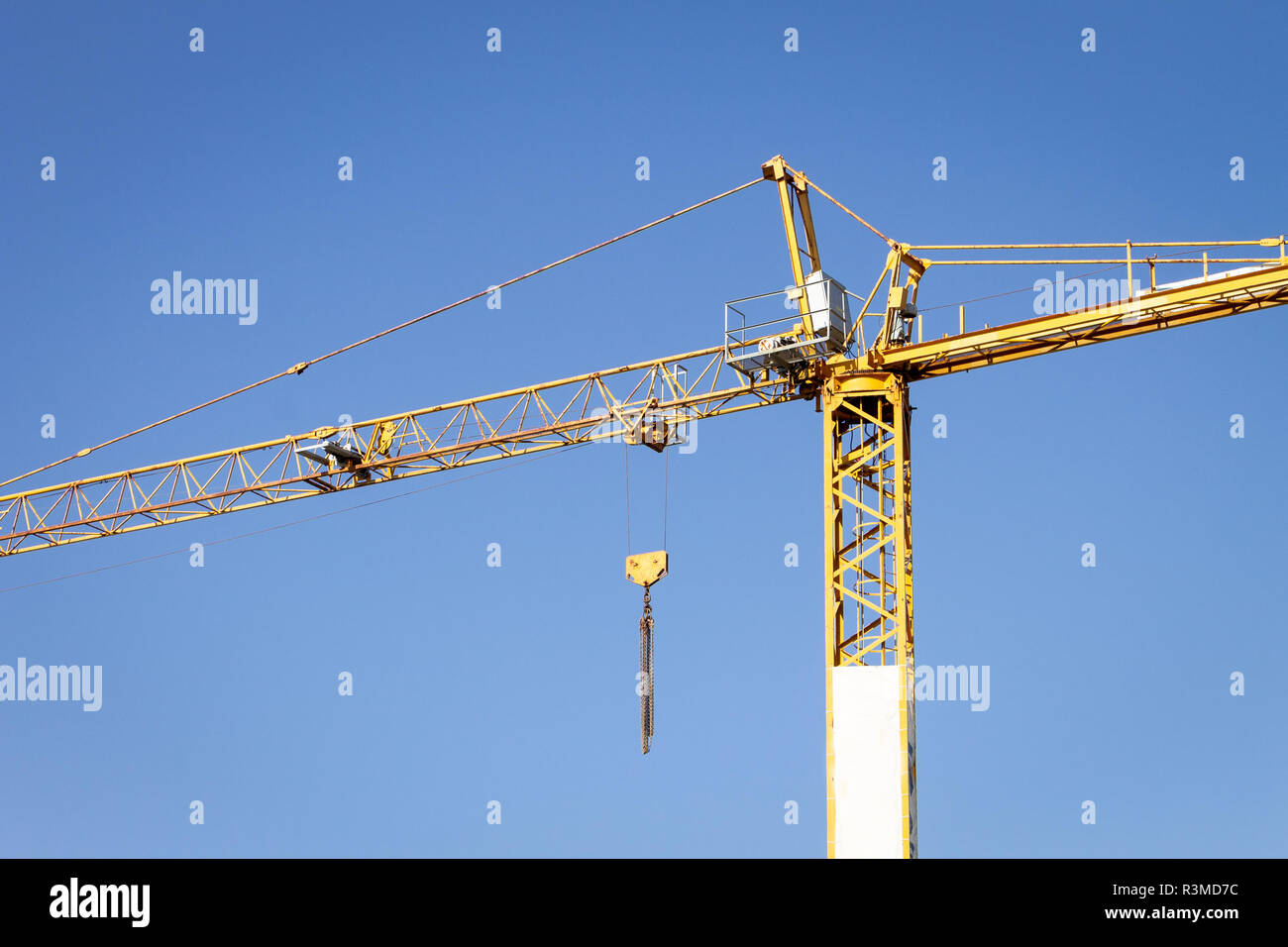 Yellow Crane on a clear blue sky background. Stock Photo