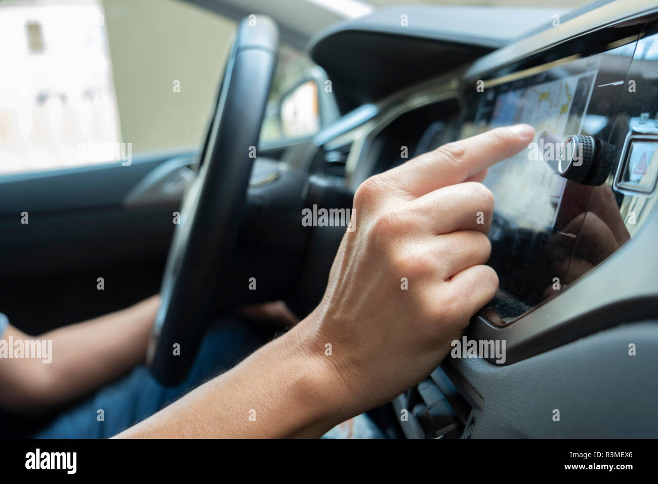closeup of a young caucasian man using the automotive navigation system of a car Stock Photo