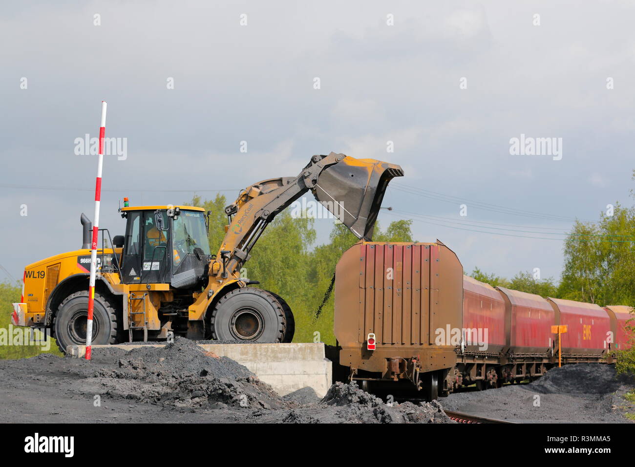 A Caterpillar 966H loading coal on to a freight train on the Recycoal Coal Recycling Plant in Rossington,Doncaster which has now been demolished' Stock Photo