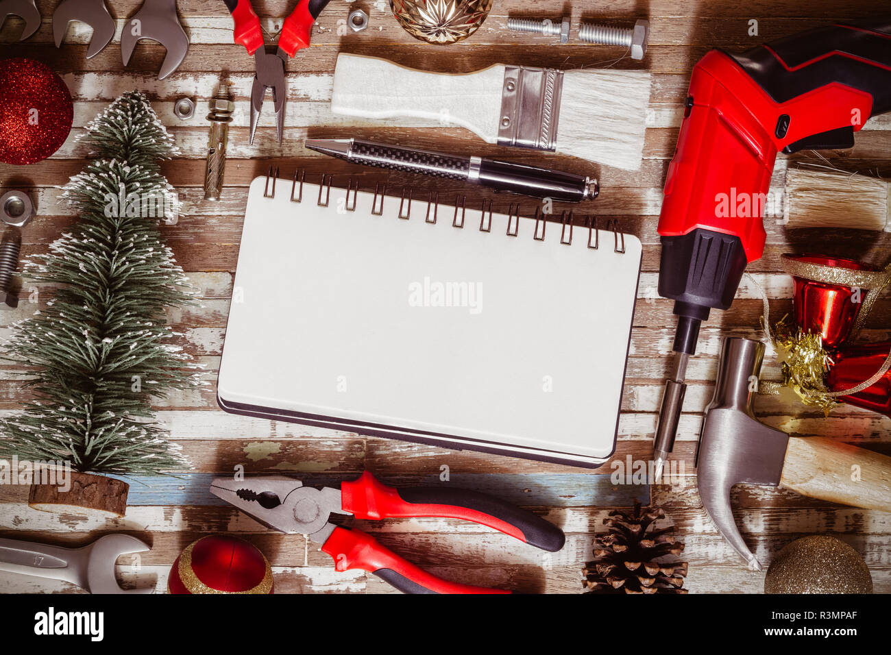 Merry christmas and Happy New year Craftsman Workspace background concept, Variety of handy DIY tools with Christmas ornament decoration. Top view wit Stock Photo