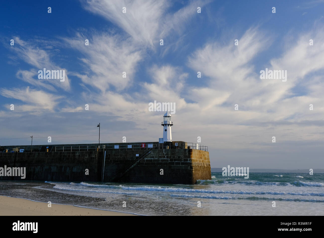 The lighthouse at the entrance to St Ives Harbour in Cornwall Stock Photo