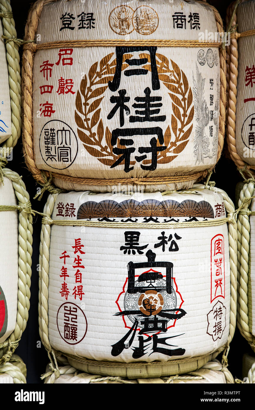 Kobe, Japan. Barrels of Sake wrapped in straw at the entrance to Ikuta Jinja Temple, as an offering Stock Photo