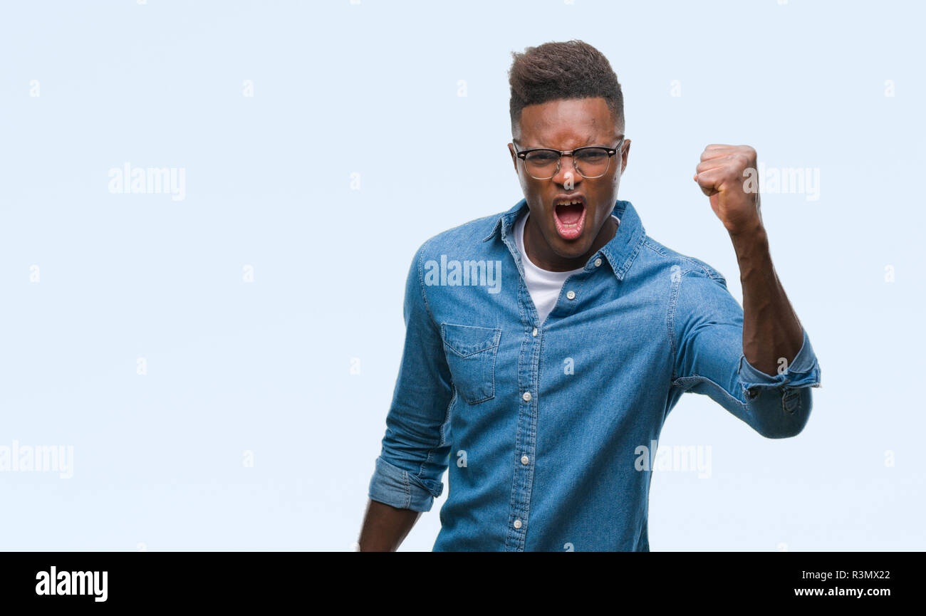 Young african american man over isolated background angry and mad ...
