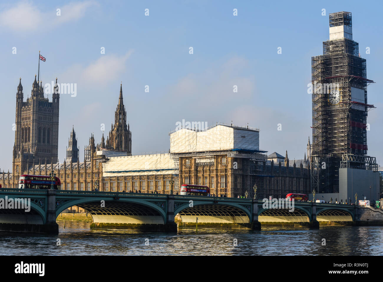 Houses of Parliament, Palace of Westminster, London, shrouded in sheeting and a framework of scaffolding during restoration repairs. Listed building Stock Photo