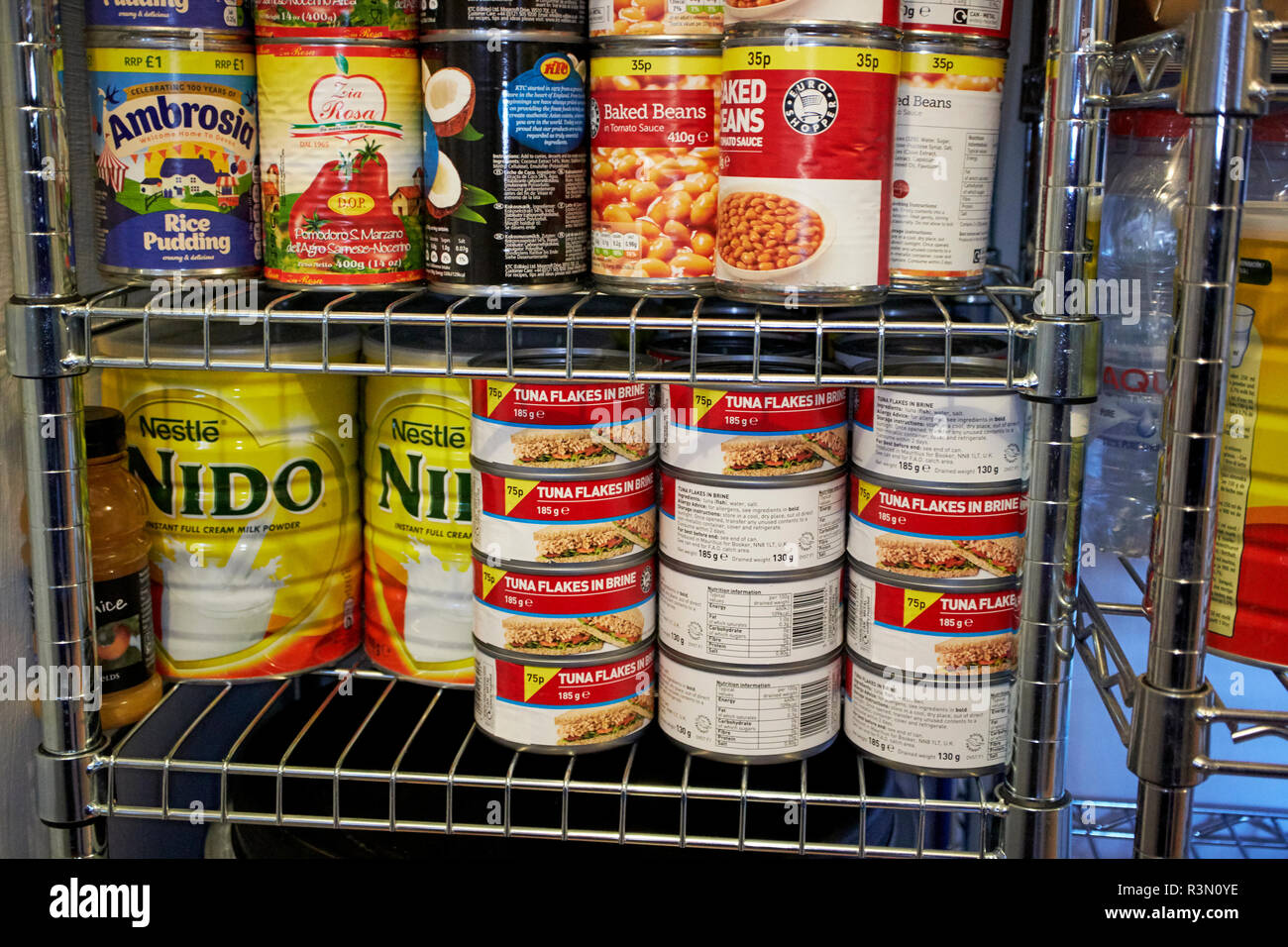 canned goods powdered milk stockpiled stored in case of global emergency such as brexit or pandemic isolation preparations preppers tinned food cans Stock Photo