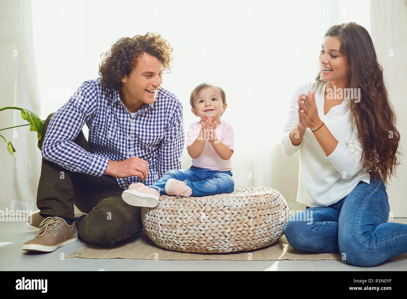 Happy family playing with baby at home.  Stock Photo