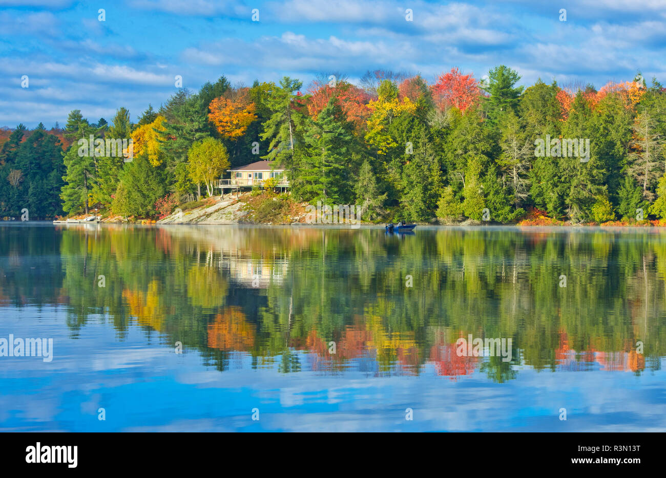 Canada, Ontario, Horseshoe Lake. Cottage in morning fog on lake. Stock Photo