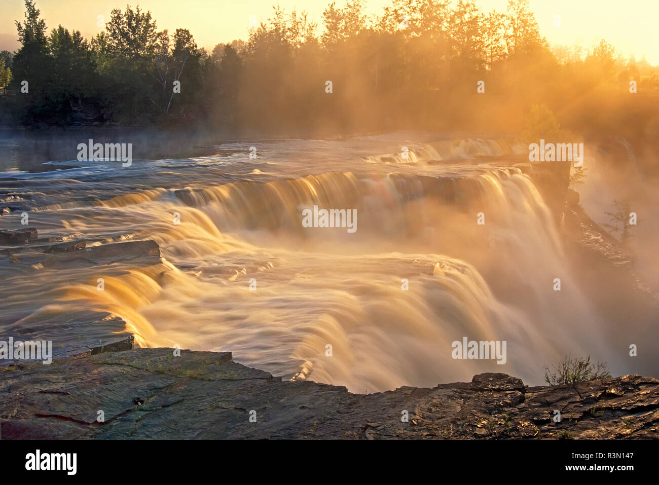 Canada, Ontario, Kakabeka. Kaministiquia River at Kakabeka Falls at sunset. Stock Photo