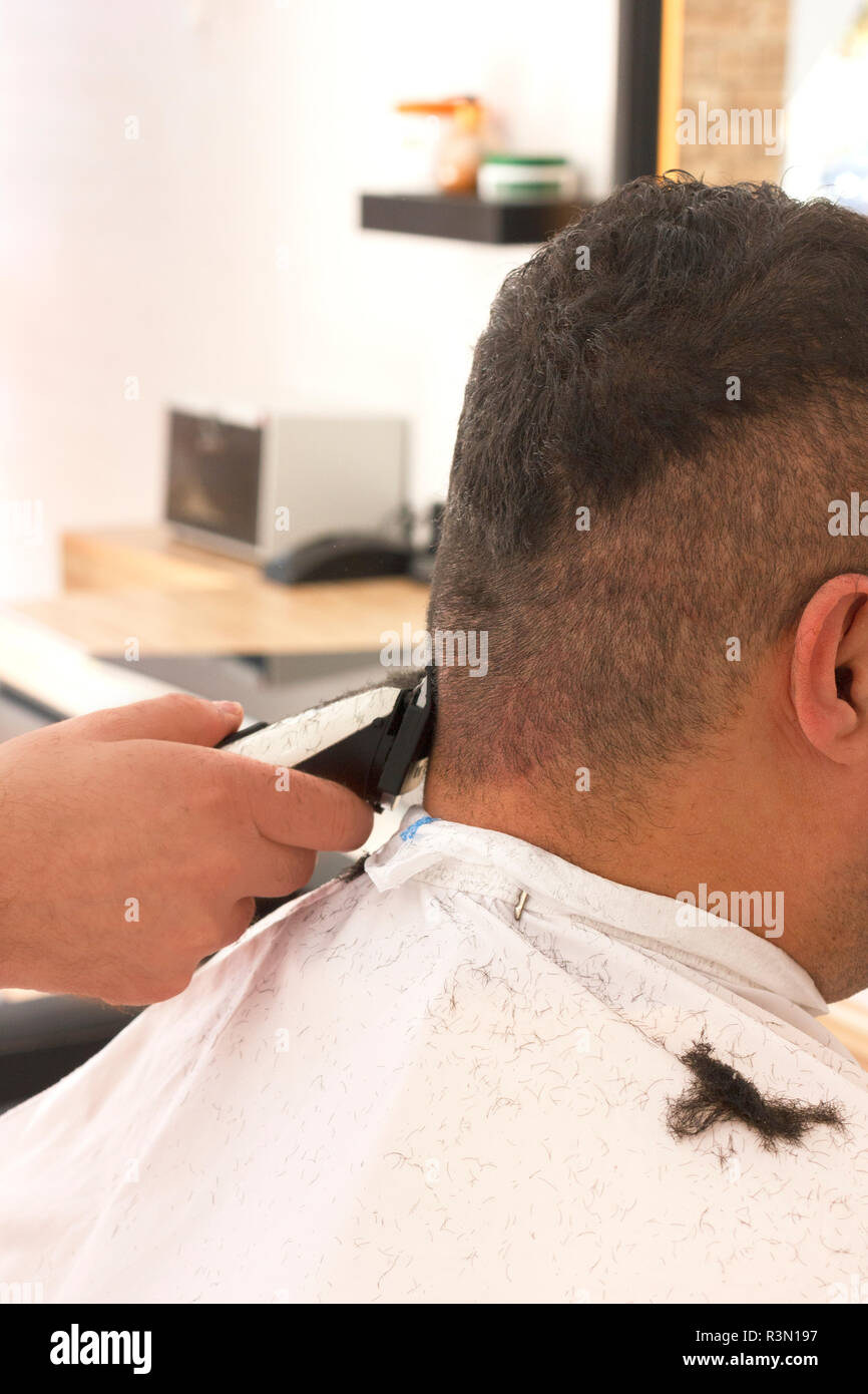 Back View Of Man Getting Short Hair Trimming At Barber Shop