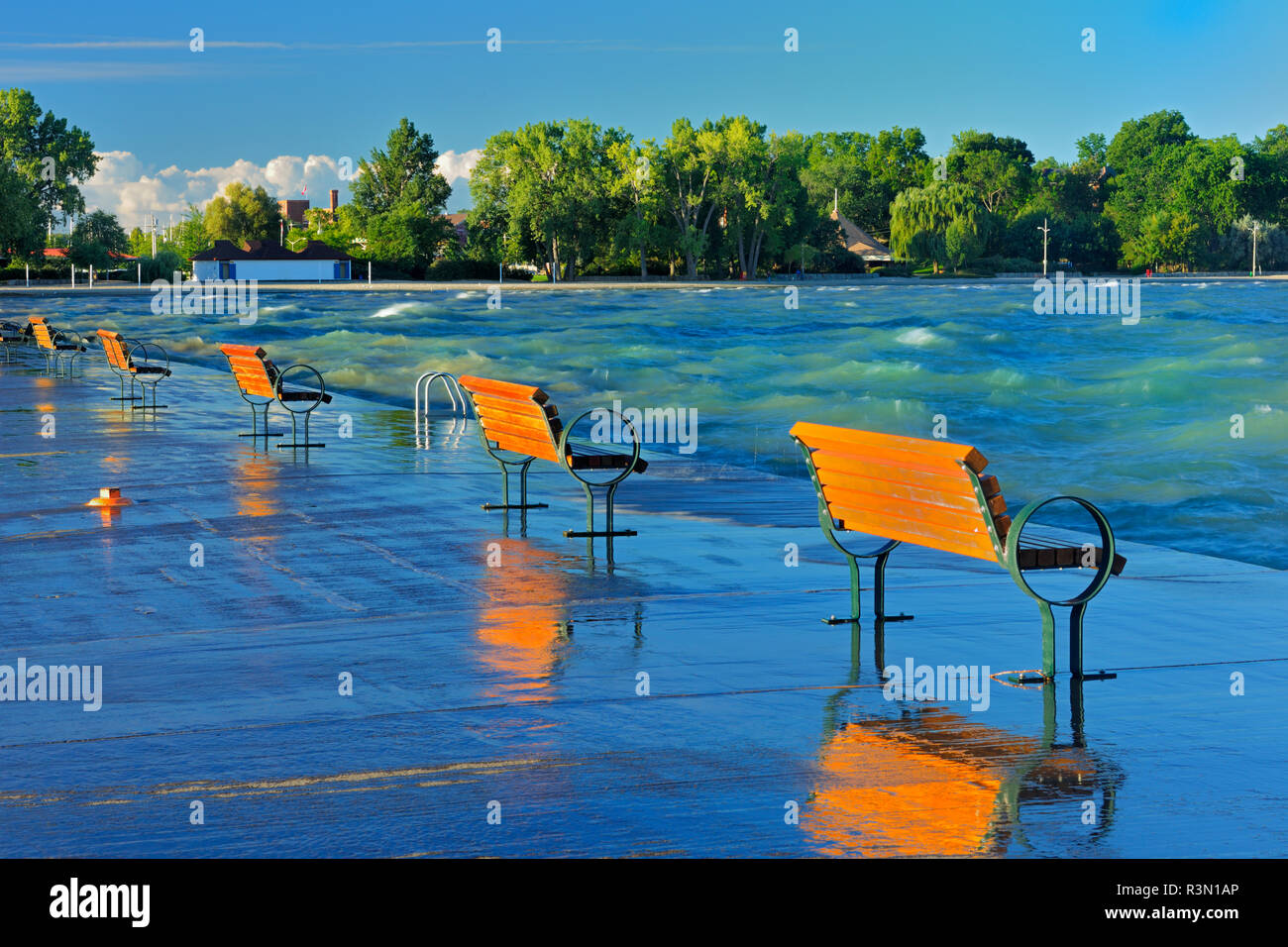 Canada, Ontario, St. Catharines. Benches on pier at sunrise on Lake Ontario. Stock Photo