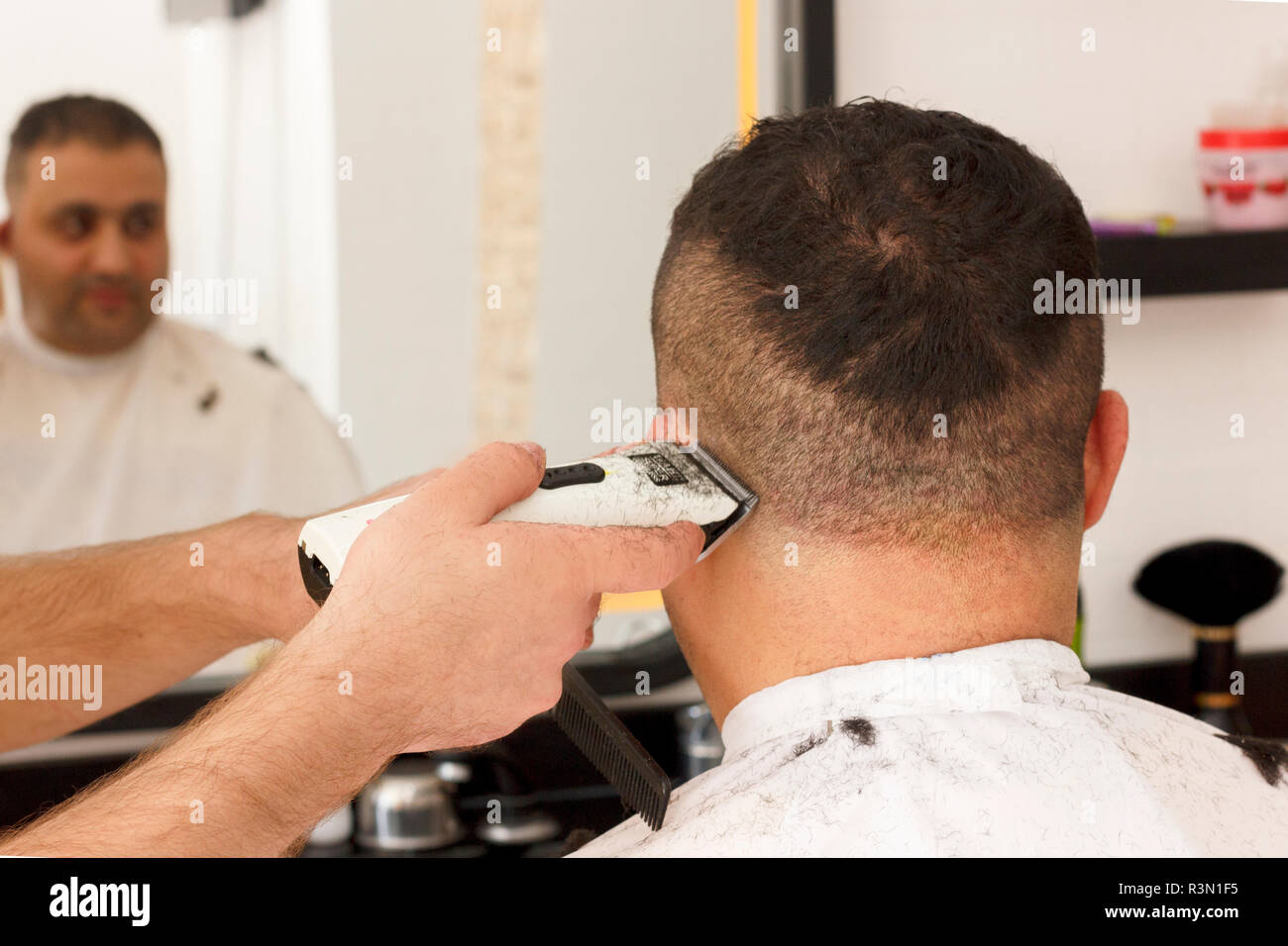 Back View Of Man Getting Short Hair Trimming At Barber Shop With A