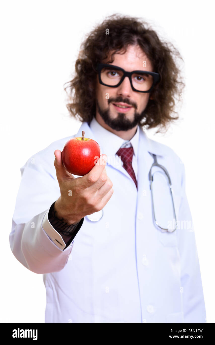 Studio shot of handsome man doctor giving red apple with focus o Stock Photo