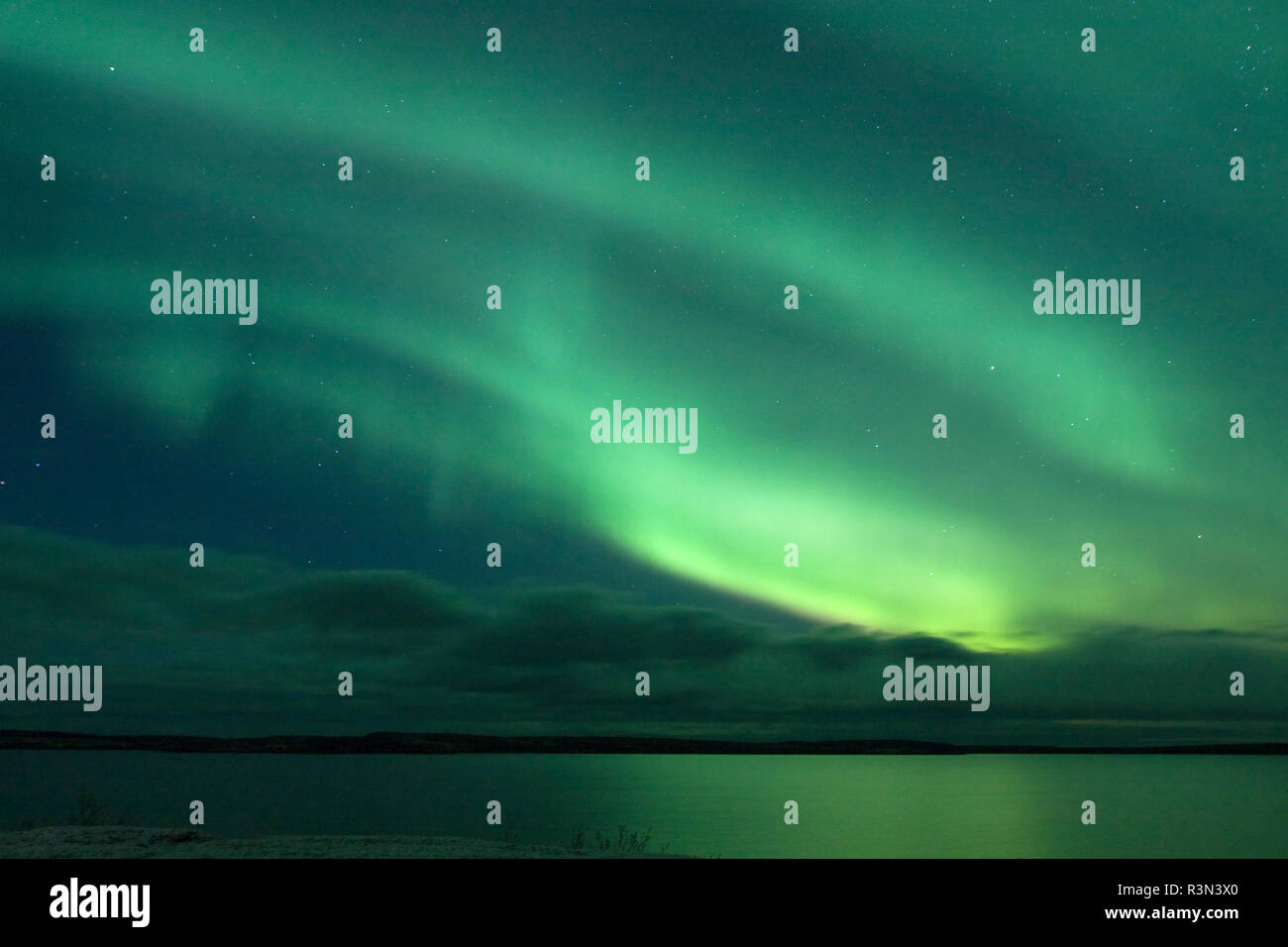 Canada, Quebec, Charlie Lake. Northern lights reflect in lake. Credit