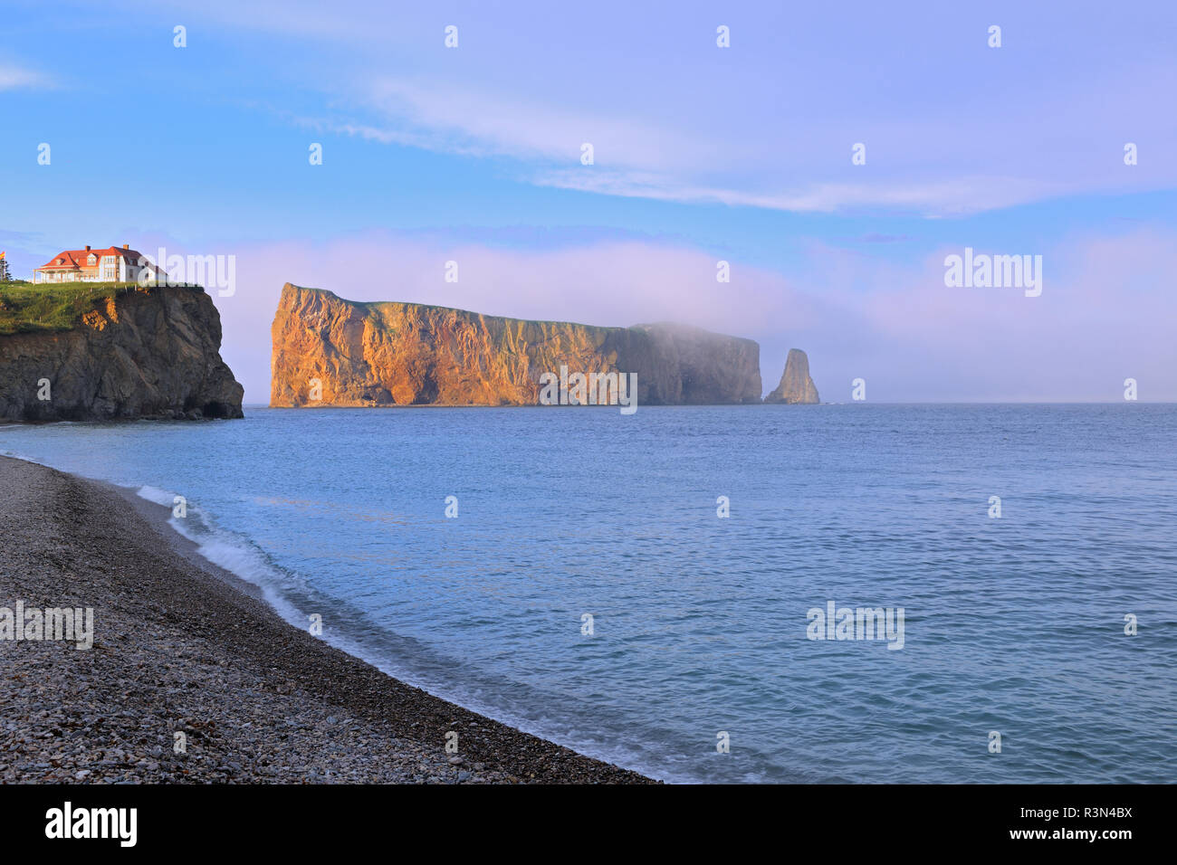Canada, Quebec, Perce. House on cliff and Perce Rock in Atlantic Ocean