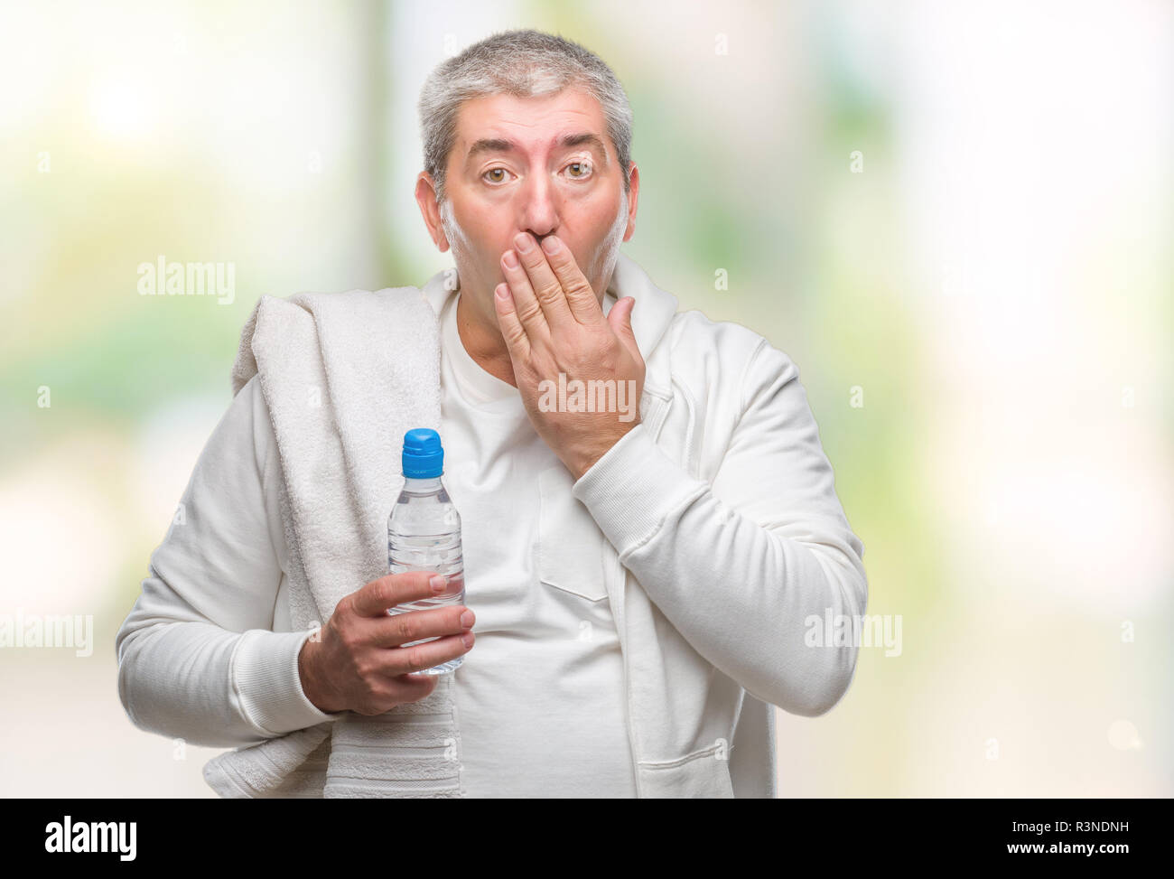 Hand Expression Tutorial Handsome senior man training holding towel and water bottle over ...