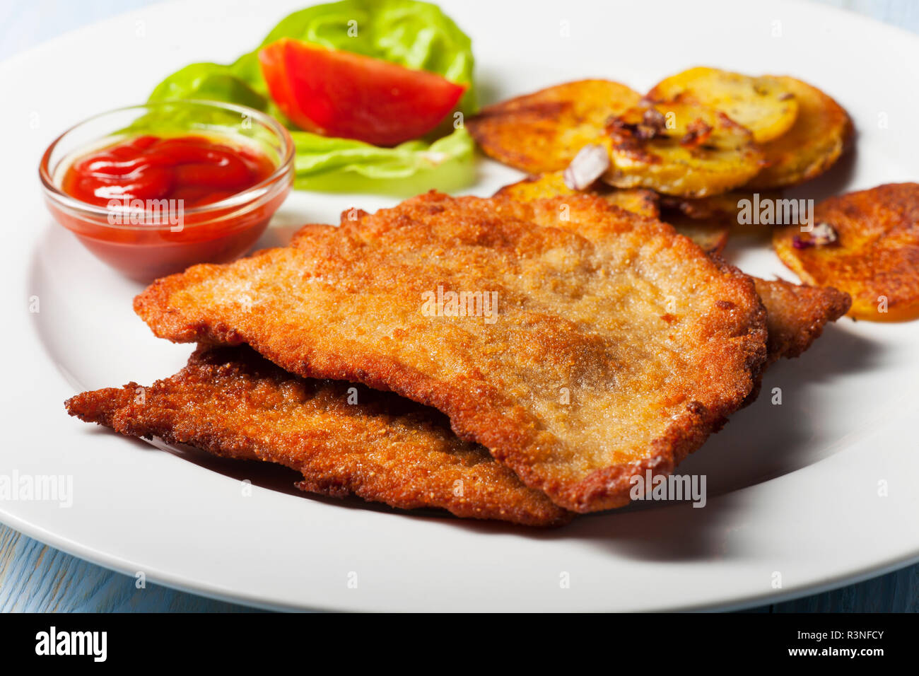 wiener schnitzel with fried potatoes Stock Photo