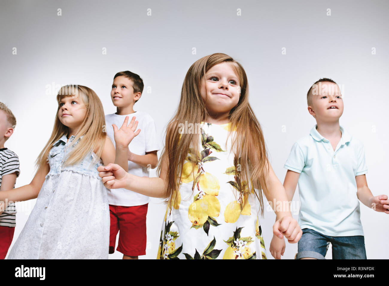 Group of fashion cute preschooler kids friends posing together and looking  at camera on a white studio background. The friendship, fashion, summer  concept. Space for text Stock Photo - Alamy