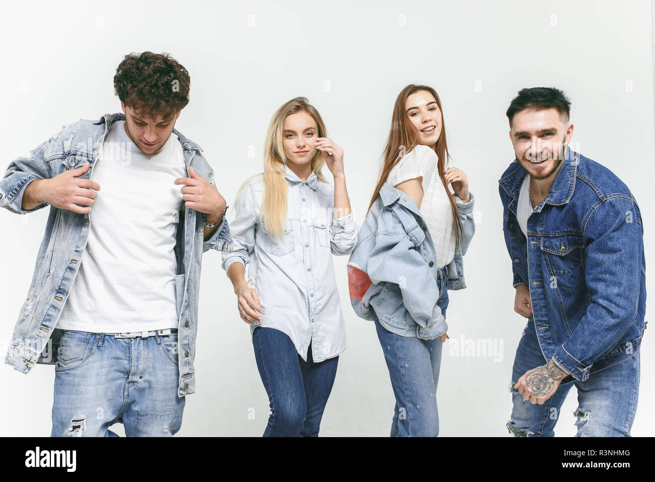 Group of smiling friends in fashionable jeans. The young men and woman  posing at studio. The fashion, people, happy, lifestyle, clothes concept  Stock Photo - Alamy
