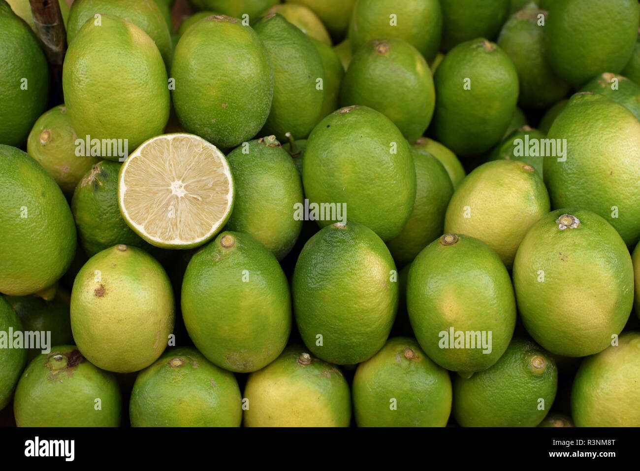 Lime lemons at grocery store. Fresh citrus fruit background. Stock Photo