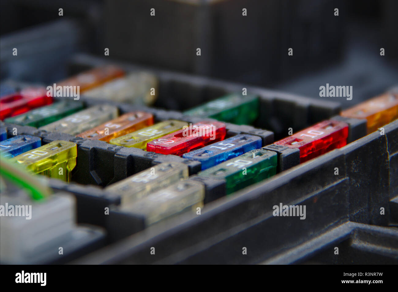 Multiple rows of fuses in the fusebox of a car. Stock Photo