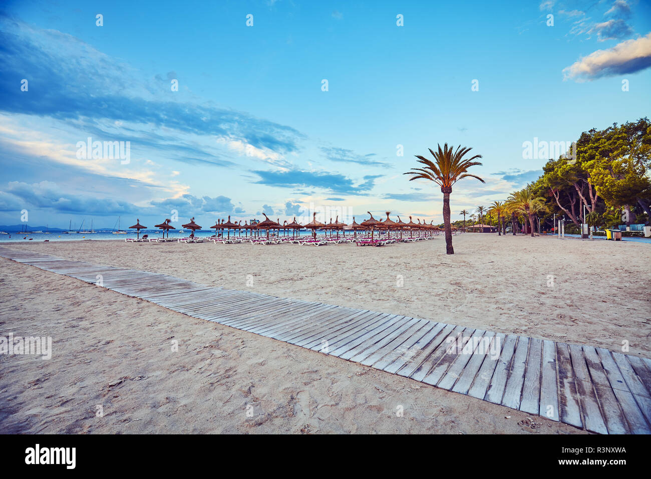 Wide angle view of an empty beach at sunrise, color toned picture, Mallorca, Spain. Stock Photo
