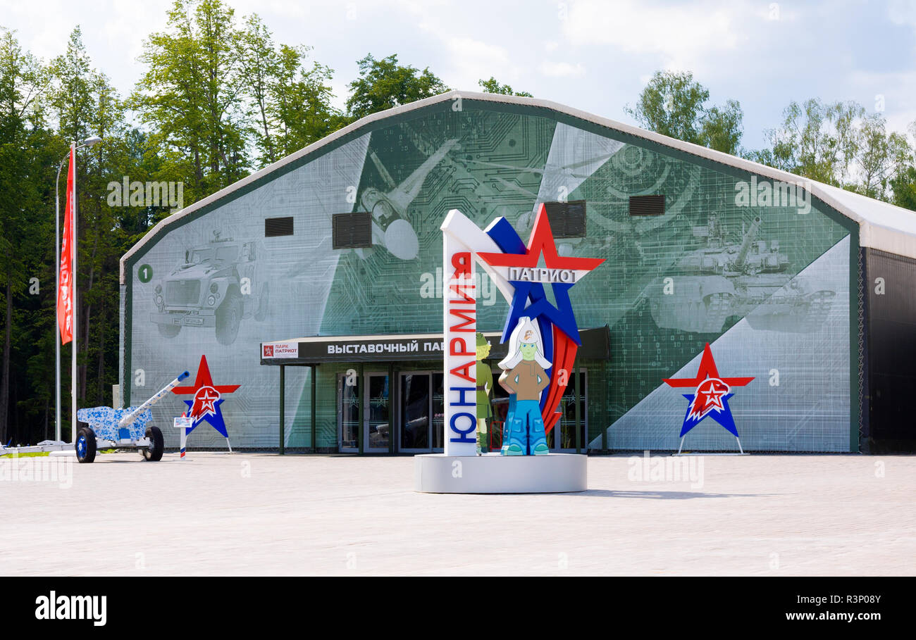 Kubinka, Moscow region, Russia - June 16, 2018: Emblem of All-Russian military-patriotic social movement 'Yunarmiya' against exhibition pavilions, Par Stock Photo