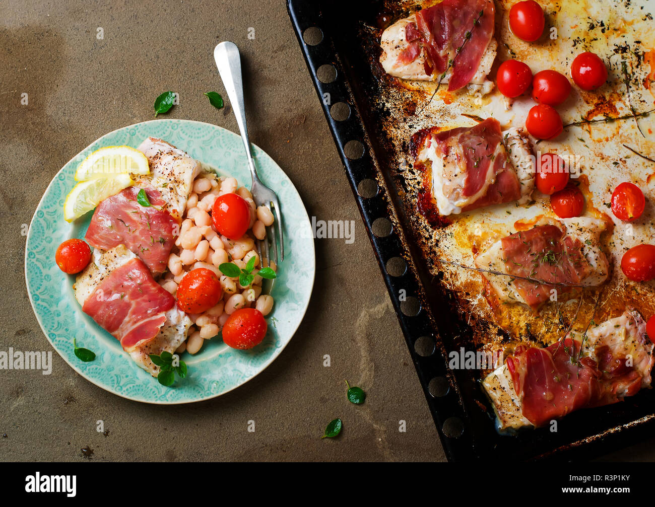 the baked cod with cherry tomato and beans.selective focus Stock Photo
