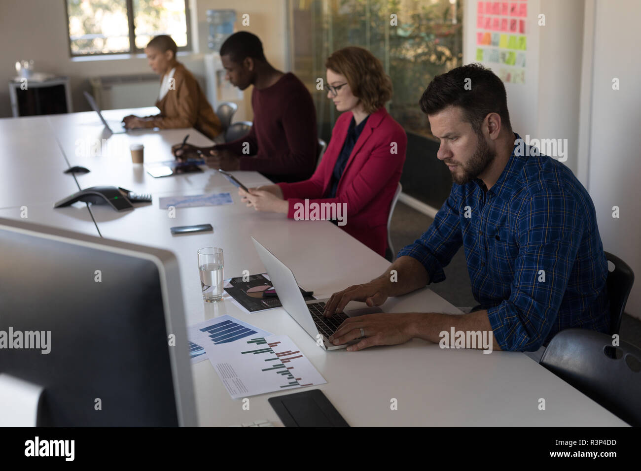 Executives working in conference room at office Stock Photo - Alamy