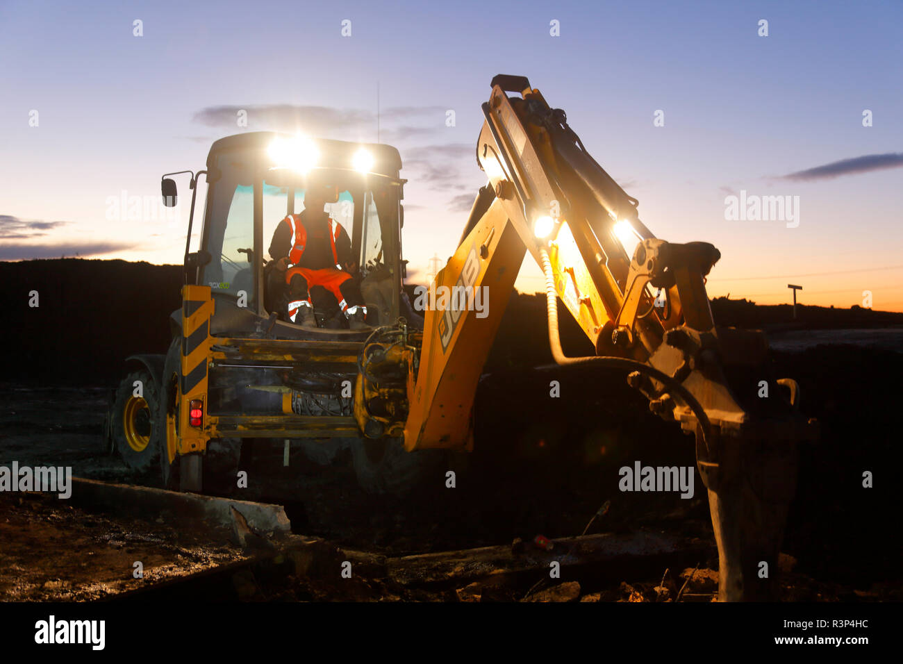 A JCB 3CX parked up on the FARRRS link road construction site compound Stock Photo
