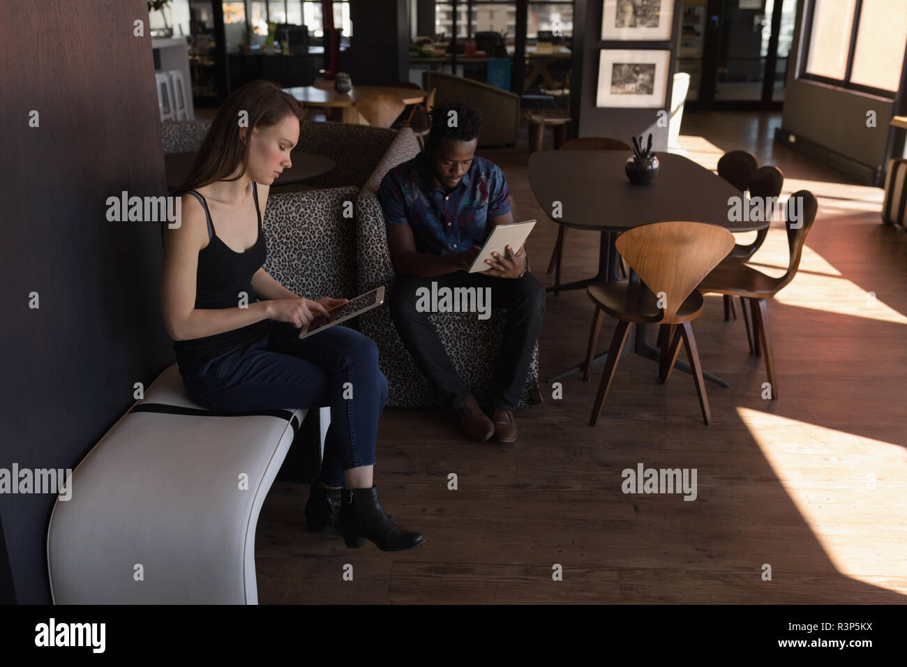 Business colleagues using digital tablet in cafeteria Stock Photo