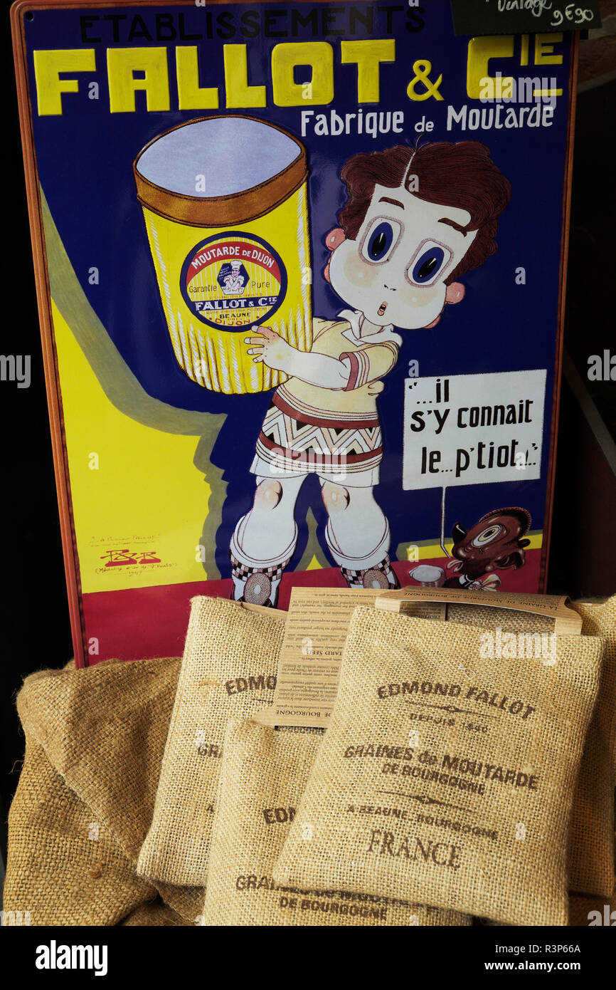 Bags of mustard seeds of IGP Burgundy and enamelled sign in a shop