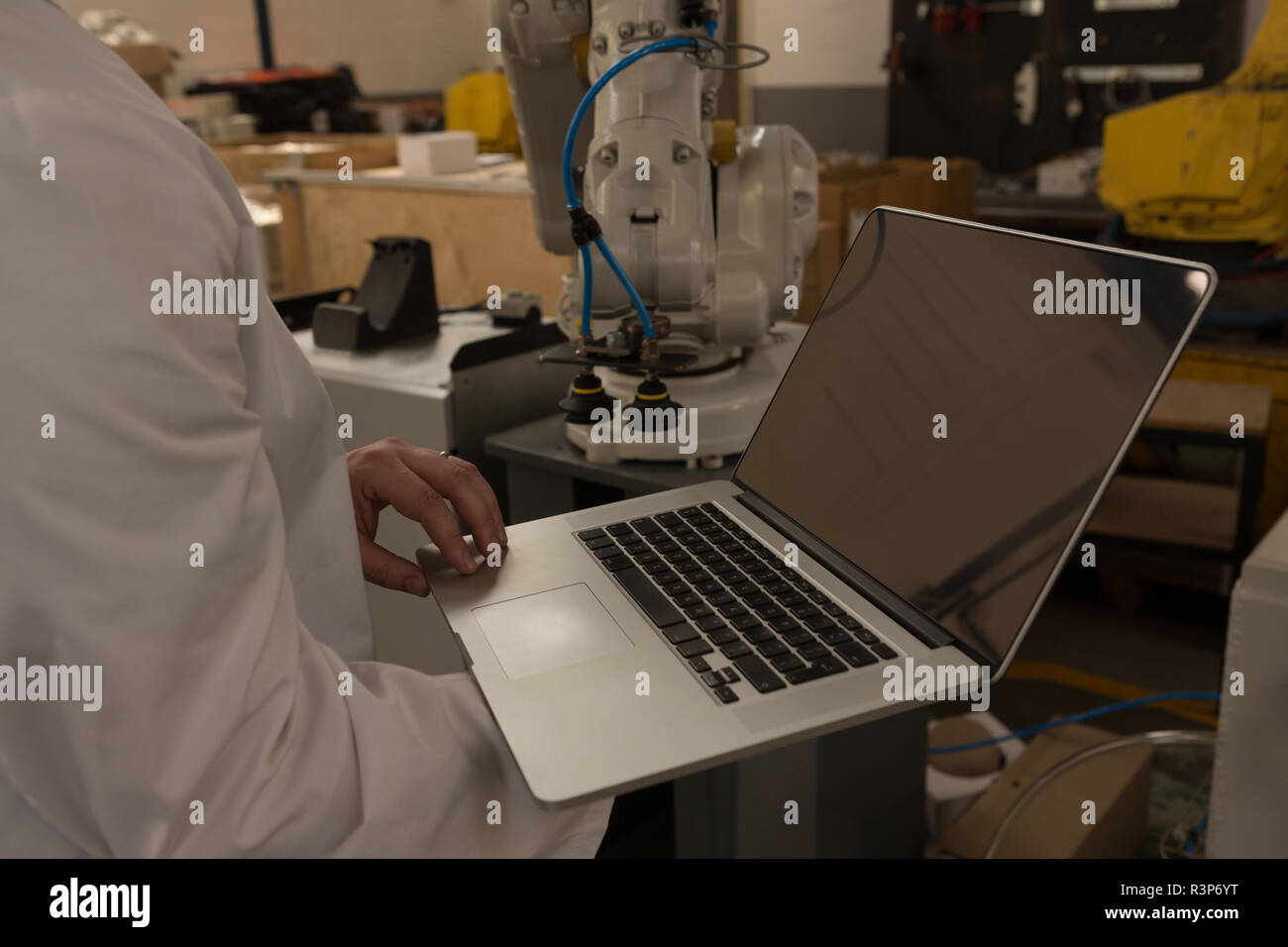 Robot holding laptop hires stock photography and images Alamy
