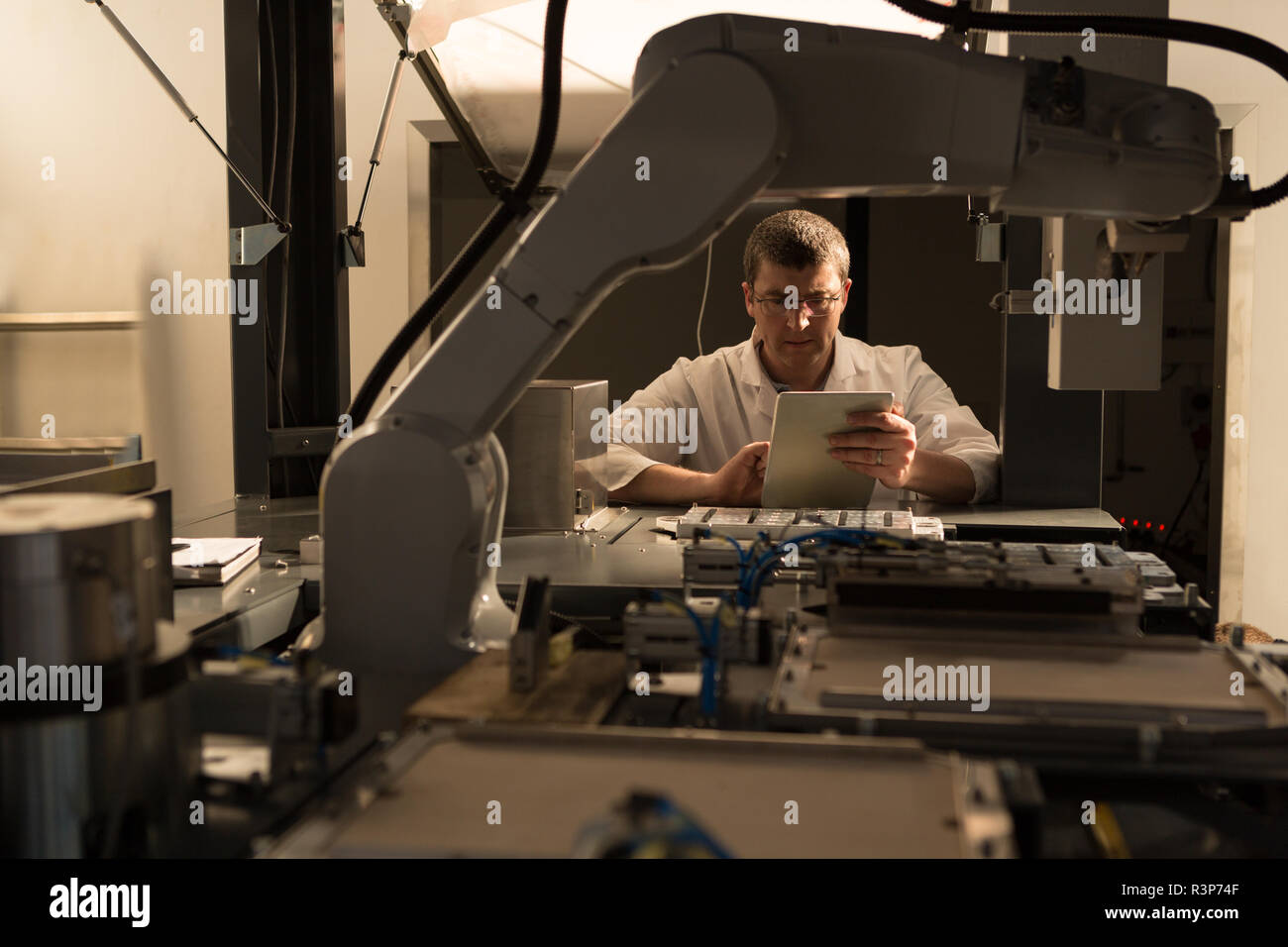 Robotic engineer using digital tablet Stock Photo