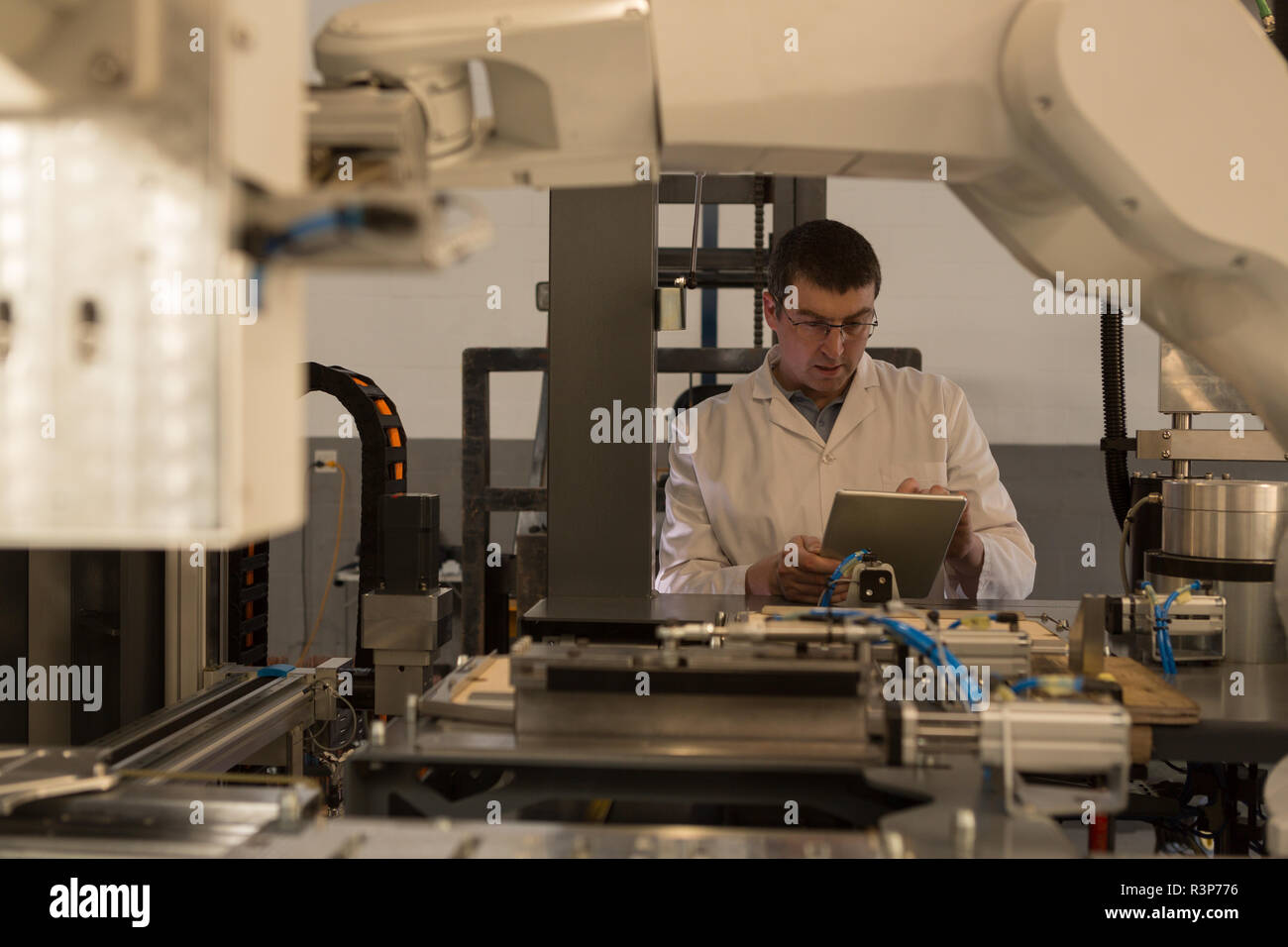 Robotic engineer using digital tablet Stock Photo