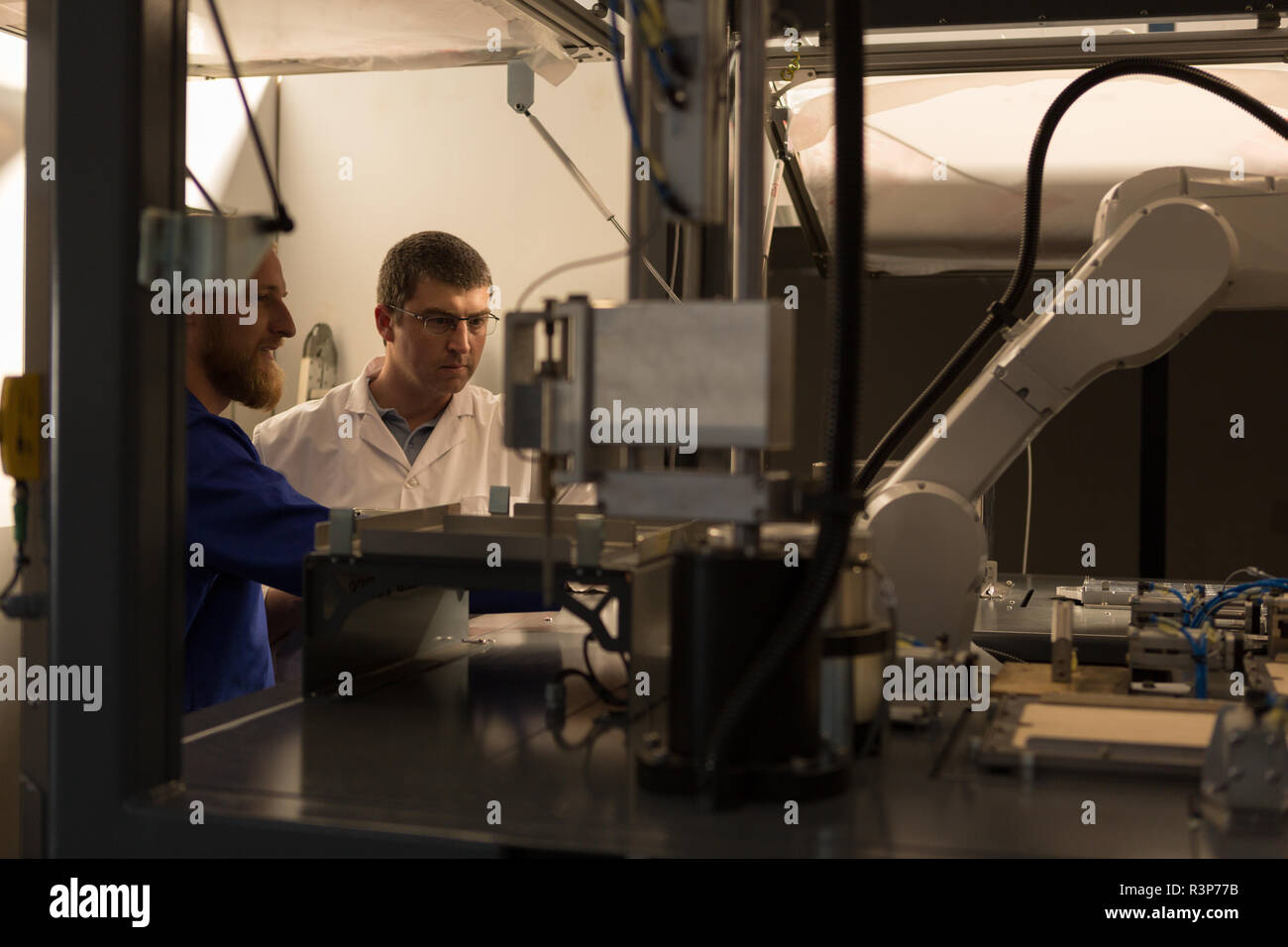 Robotic engineers working in warehouse Stock Photo