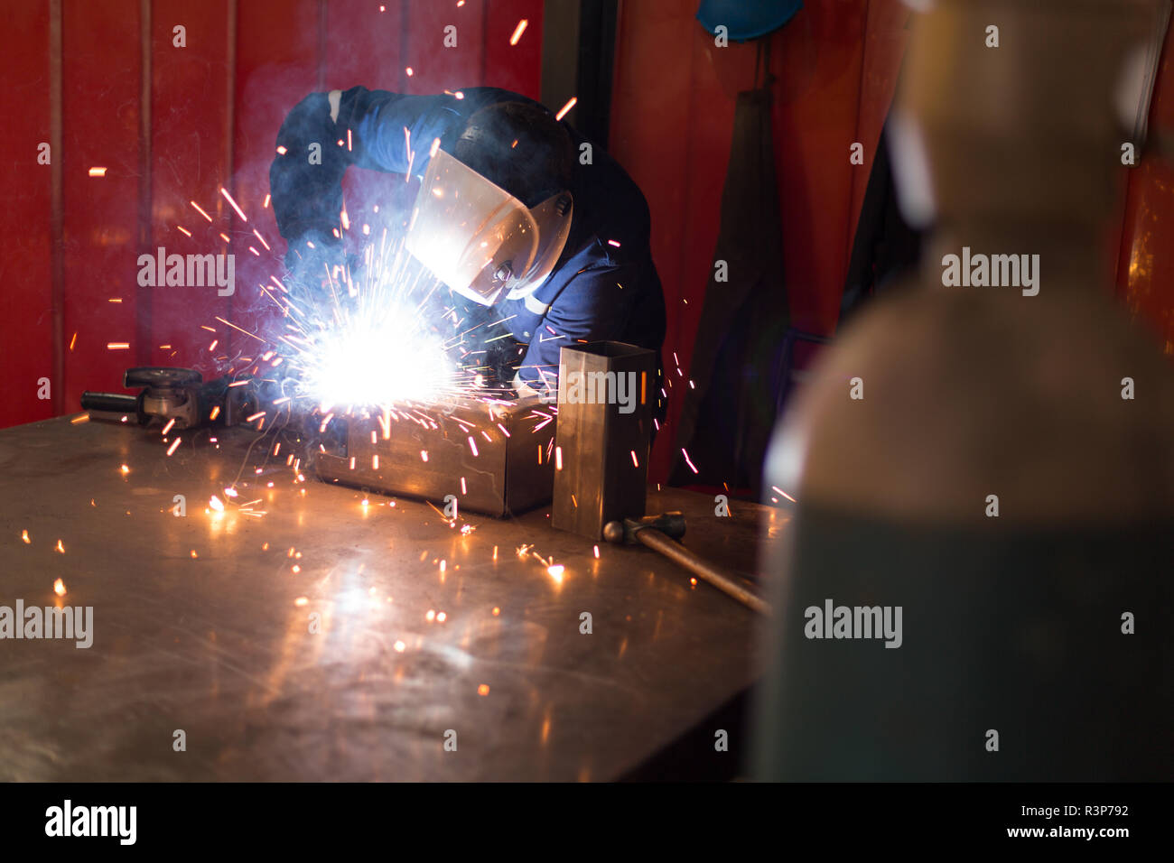 Robotic engineers using welding torch Stock Photo