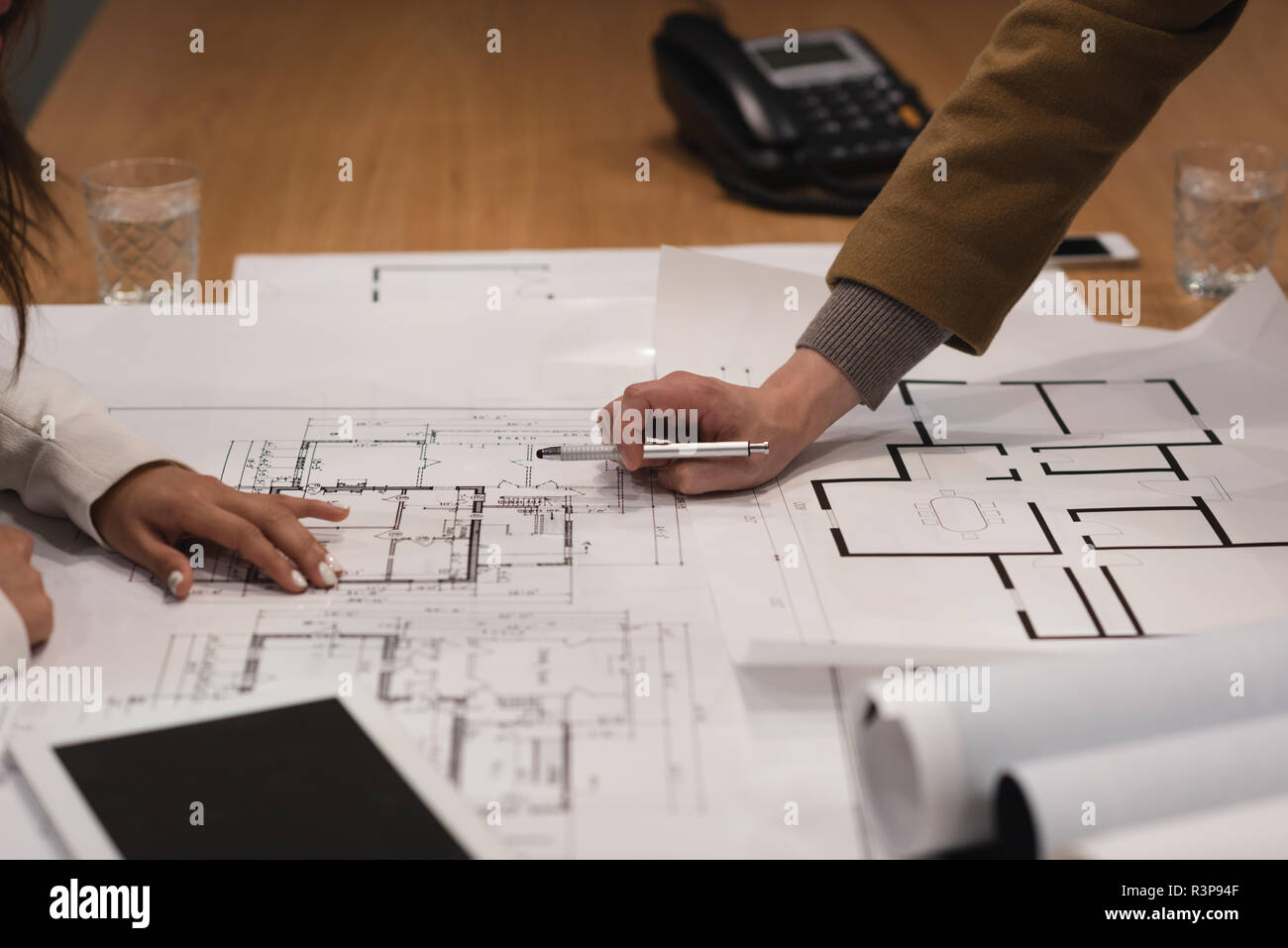 Executives discussing over blueprint Stock Photo