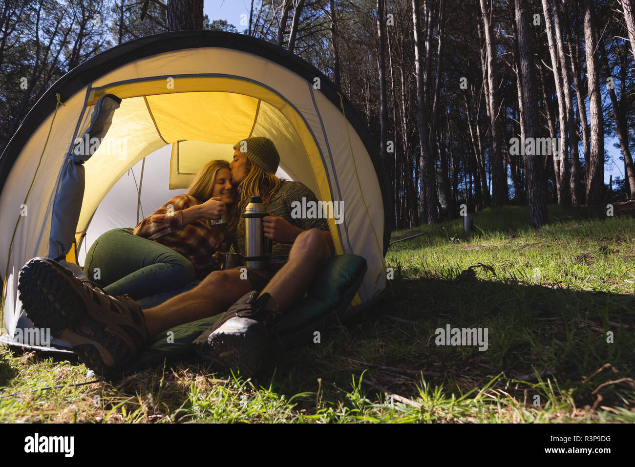 Couple having coffee in tent Stock Photo