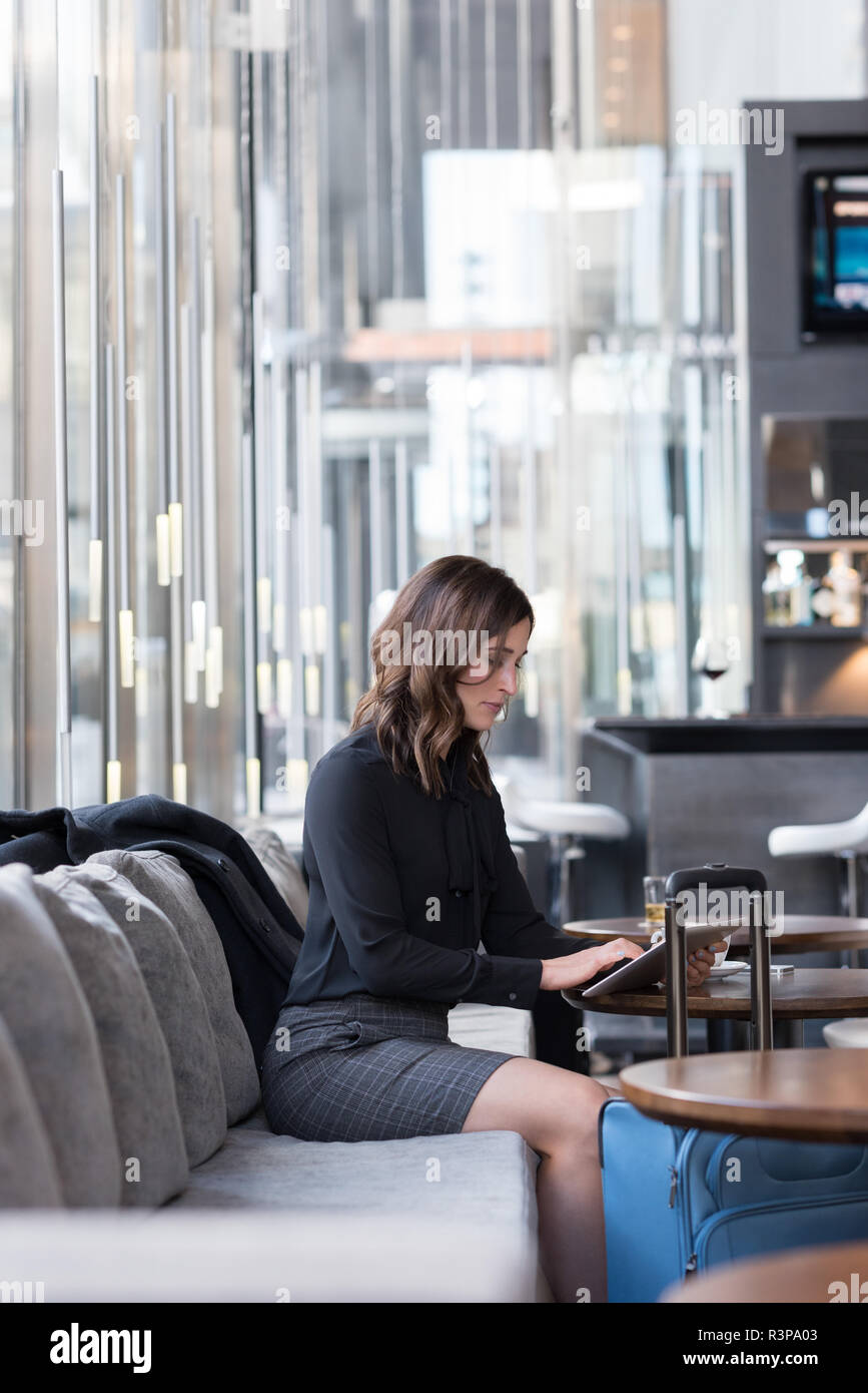 Businesswoman using digital tablet on sofa Stock Photo