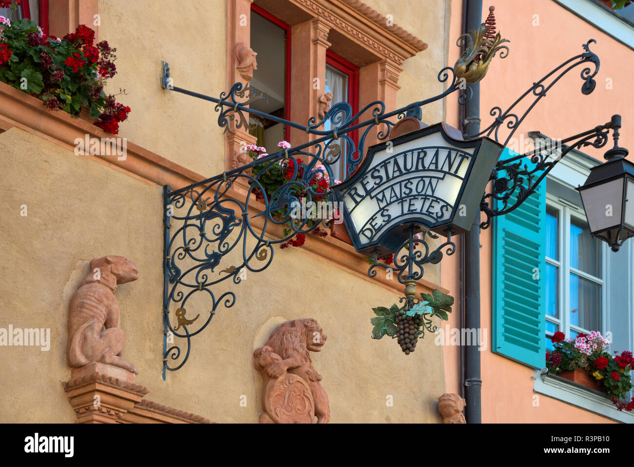 France, Alsace, Colmar. Entrance sign for a restaurant in the famous Maison des Tetes (House of Heads) building. Stock Photo