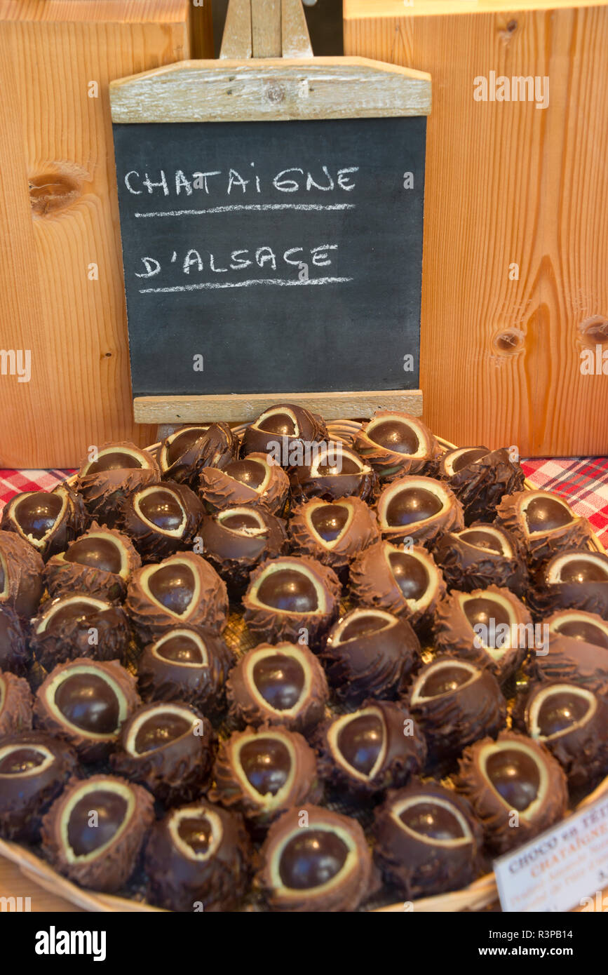 France, Alsace, Colmar. Display of chestnuts for sale outside of a market in the street of Colmar. Stock Photo
