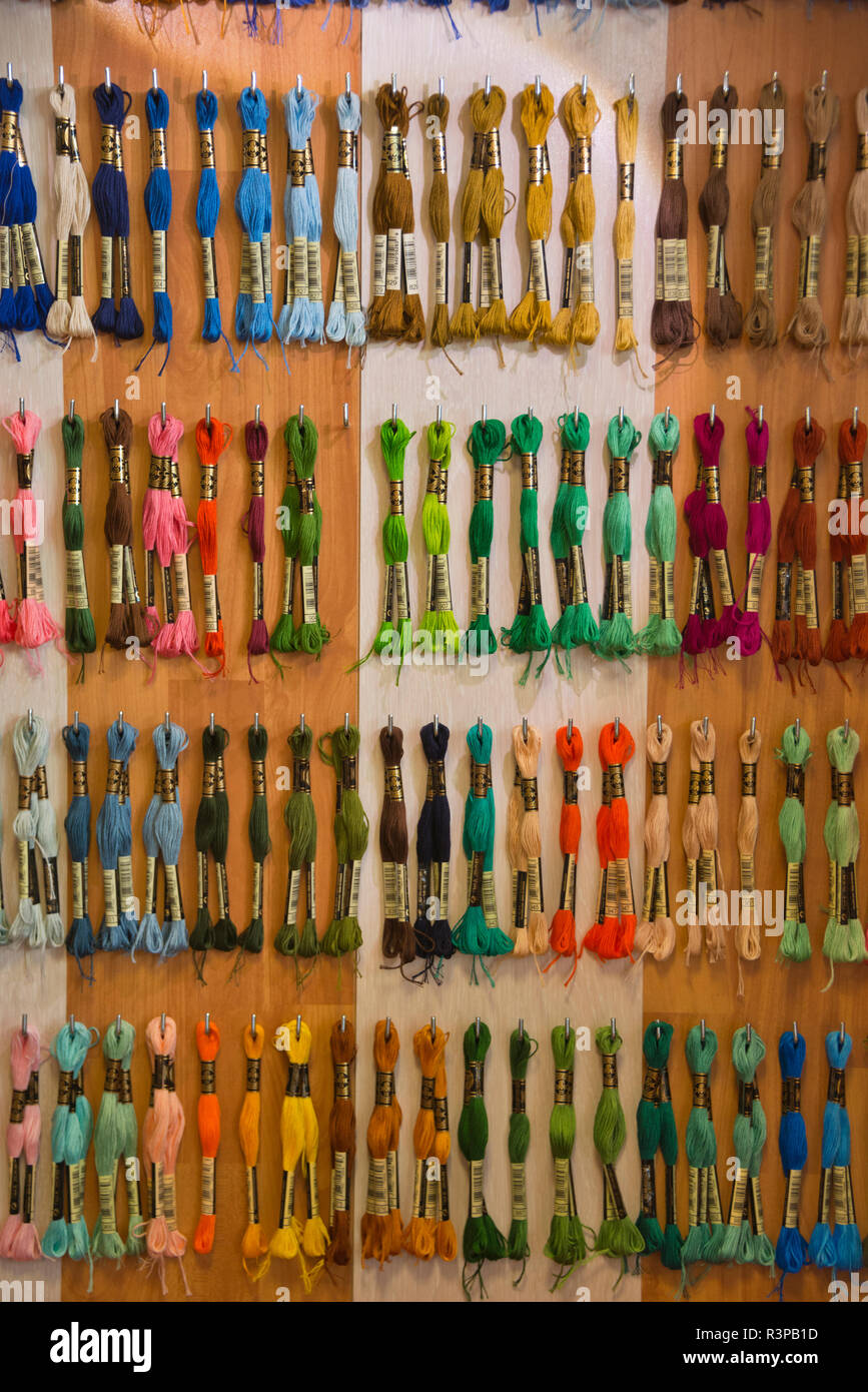 France, Alsace, Colmar. A board of colorful thread skeens in a quilt shop in Colmar. Stock Photo