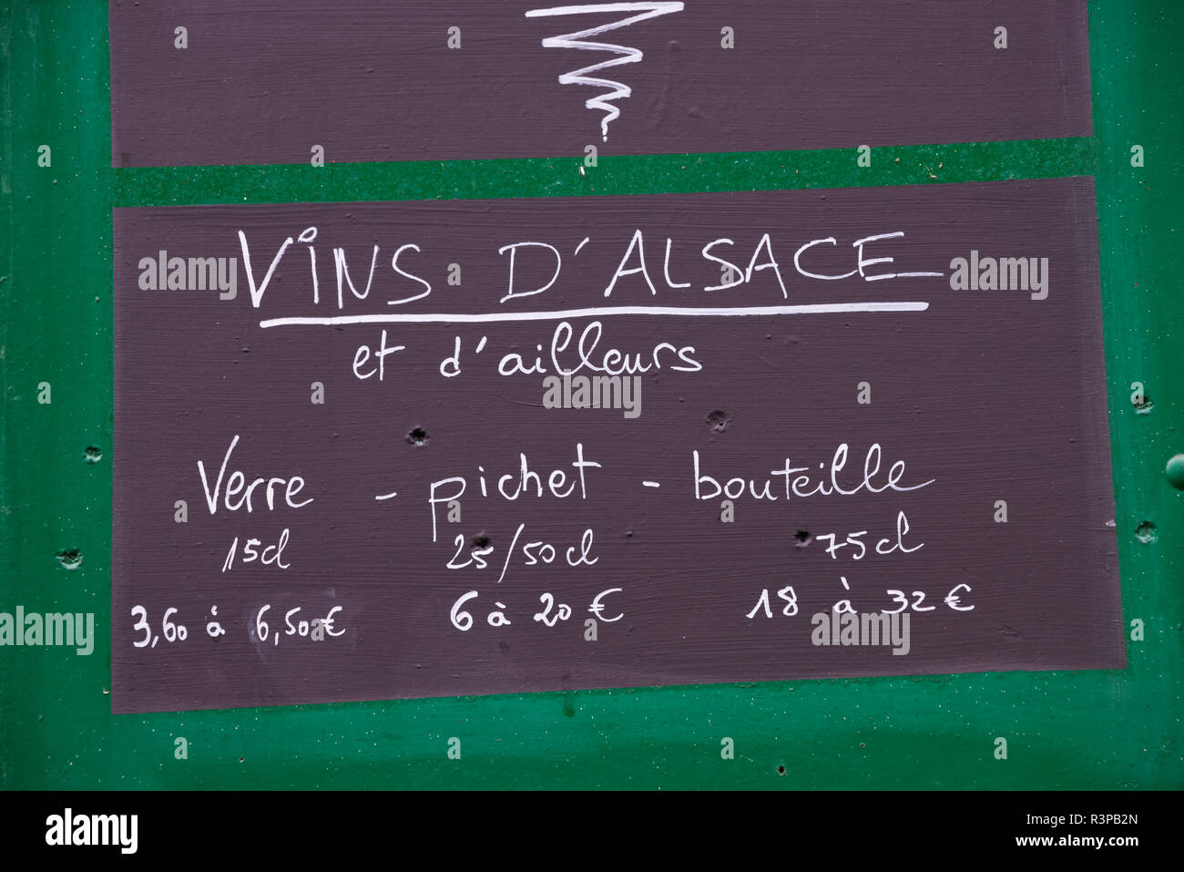 European Union, France, Alsace, Eguisheim village. Chalkboard sign outside a restaurant advertising wine prices. Stock Photo