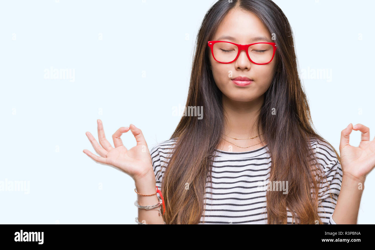 Young asian woman wearing glasses over isolated background relax and