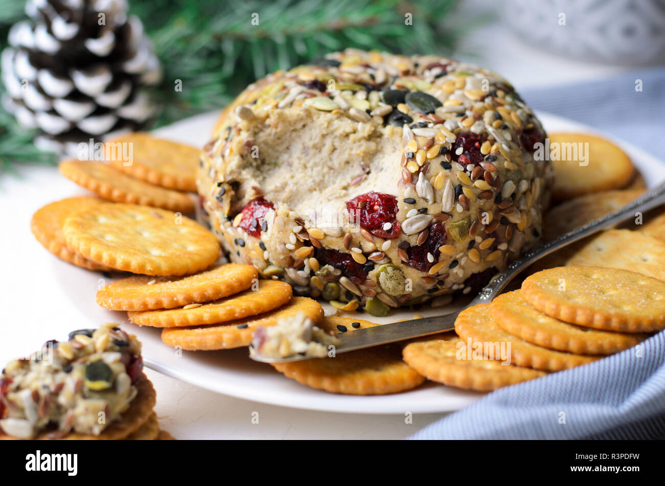 Vegan Cheese Ball Appetizer Served with Crackers, Hummus or Nut Butter Spread Stock Photo
