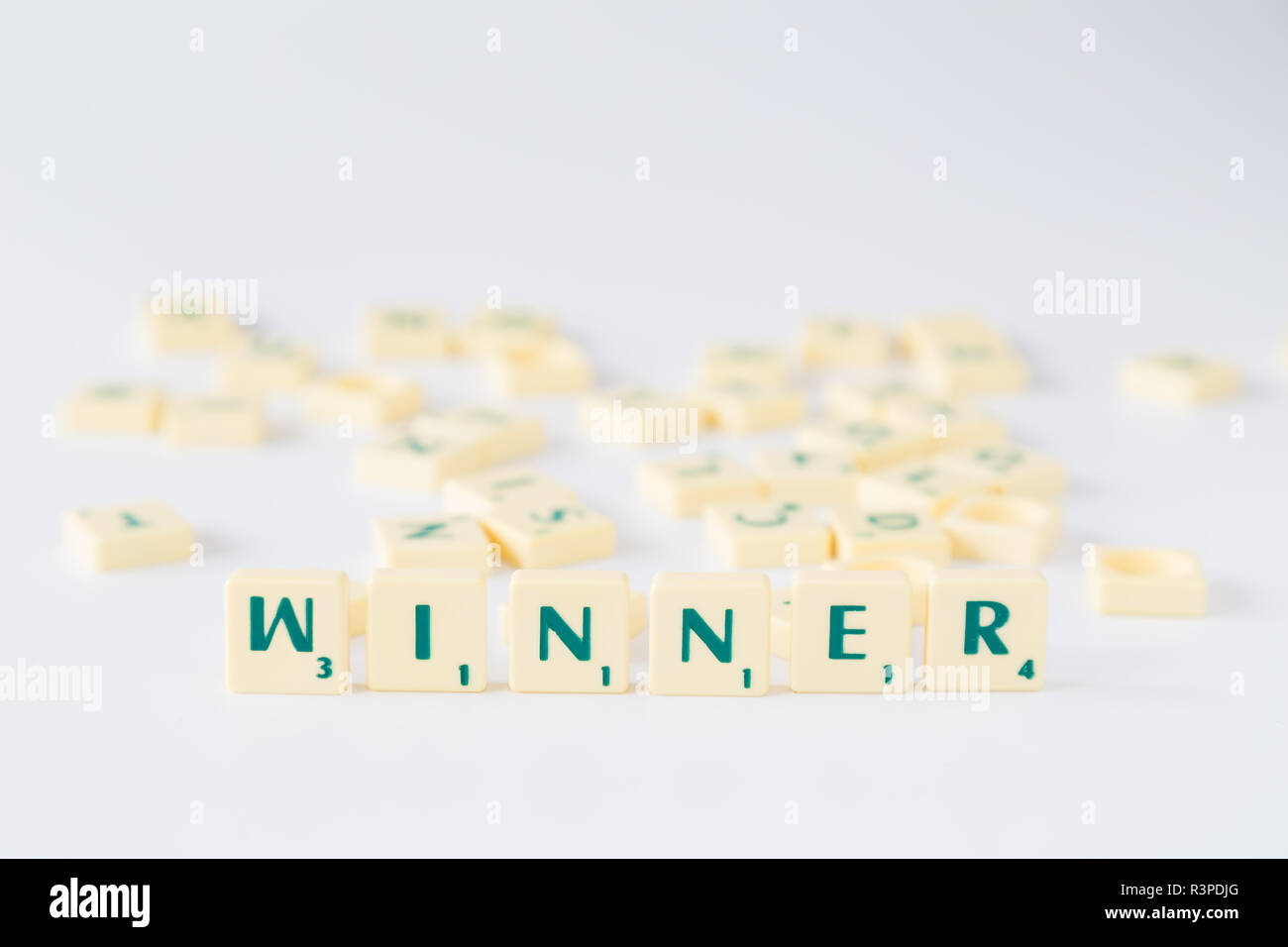 Focus on the word "Winner" made of Scrabble game letter tiles with