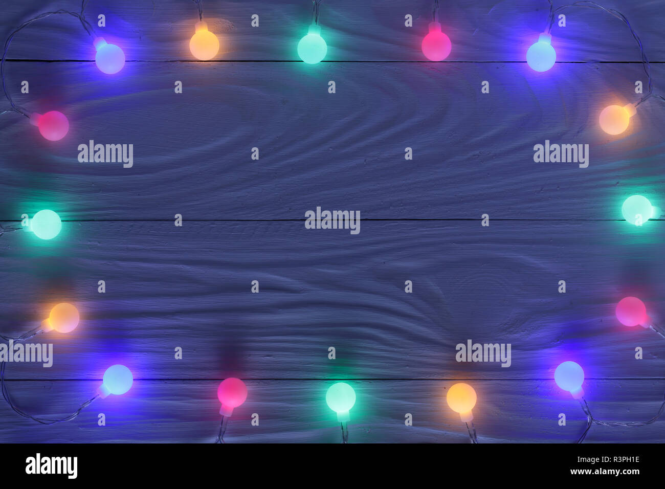 christmas garland lights on dark wooden background with copy space for ...