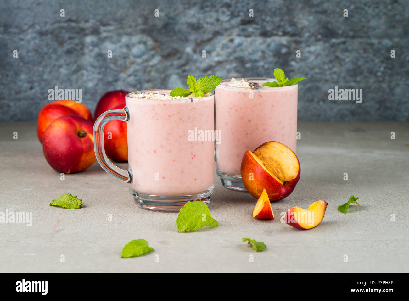 Strawberries And Peaches Smoothie In Glass Jars On Concrete
