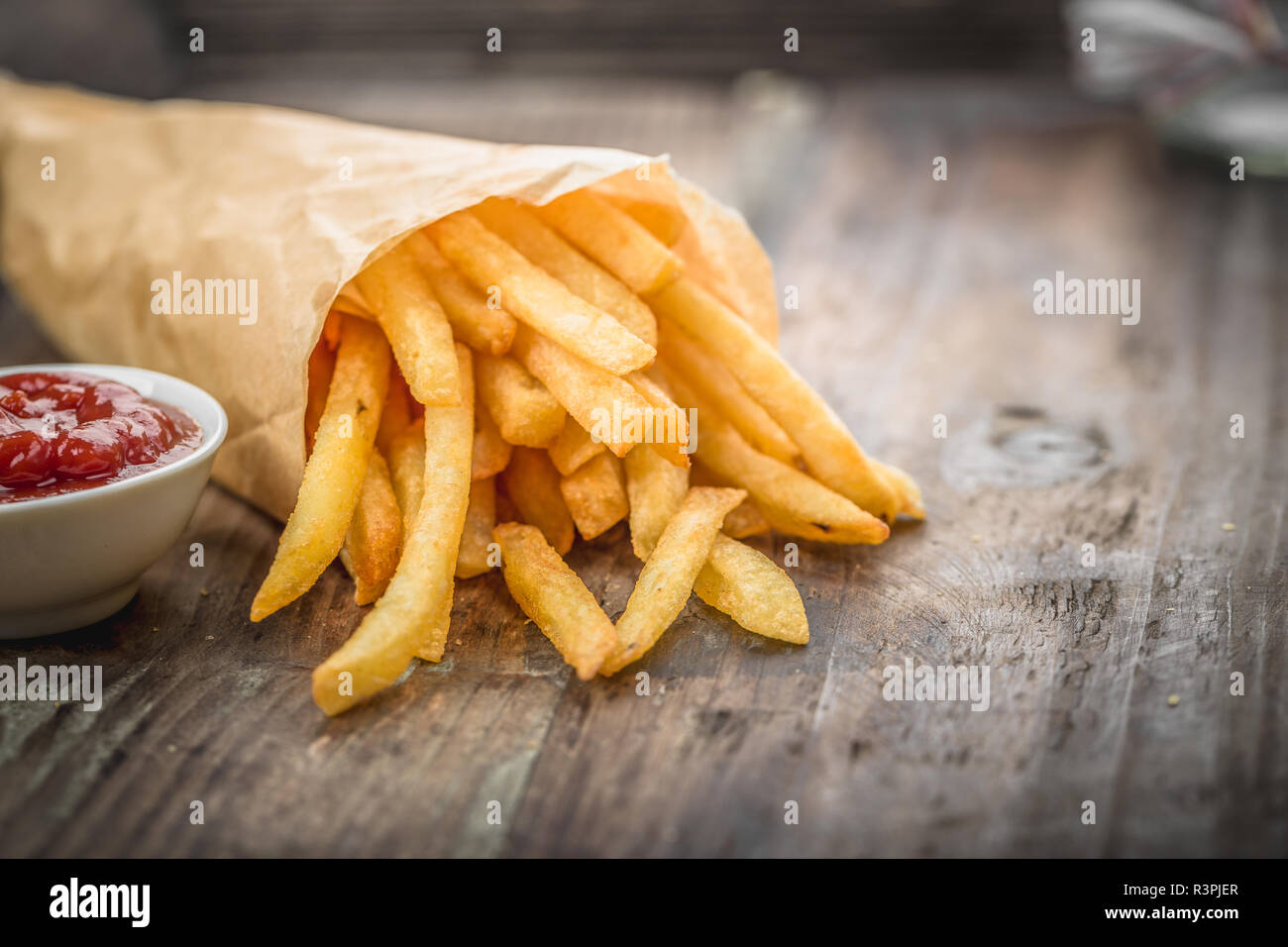 Fresh fried french fries with ketchup on wooden background Stock Photo