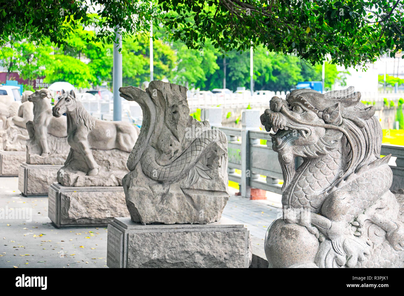 Chinese zodiac animal statues along a water canal in the longhua